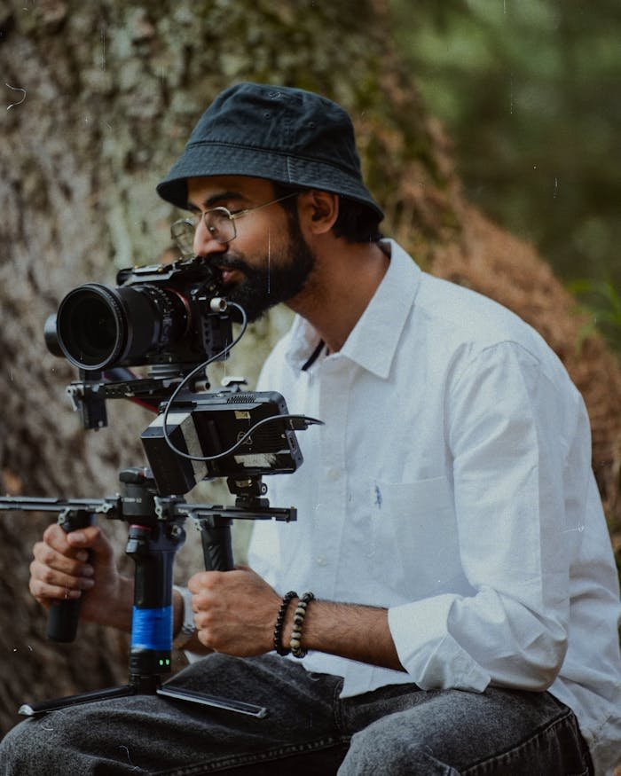 services-05 Adult male using professional camera equipment in an outdoor setting.